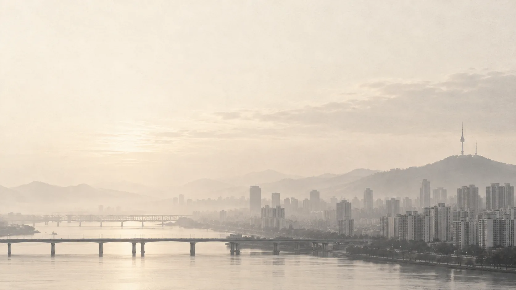 Morning light rises over Seoul, the Han River, and the N Seoul Tower.